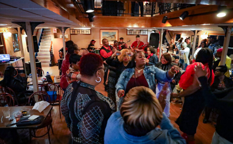 A crowded dance floor during a performance by Skeet Rodgers on a Blues Cruise